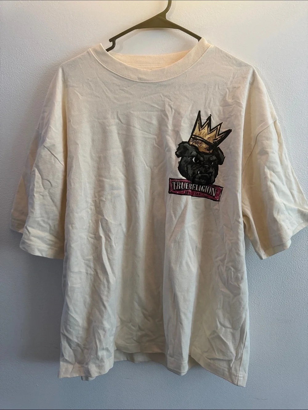 True Religion Cream Short Sleeve Tee with Crowned Dog Graphic and Brand Banner